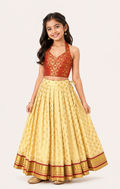 Girl wearing a red brocade blouse with a cream-gold flared lehenga choli set from Lana Fashion Studio